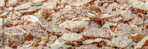 Muesli. Close-up of muesli, breakfast cereals scattered on the table. Healthy food banner