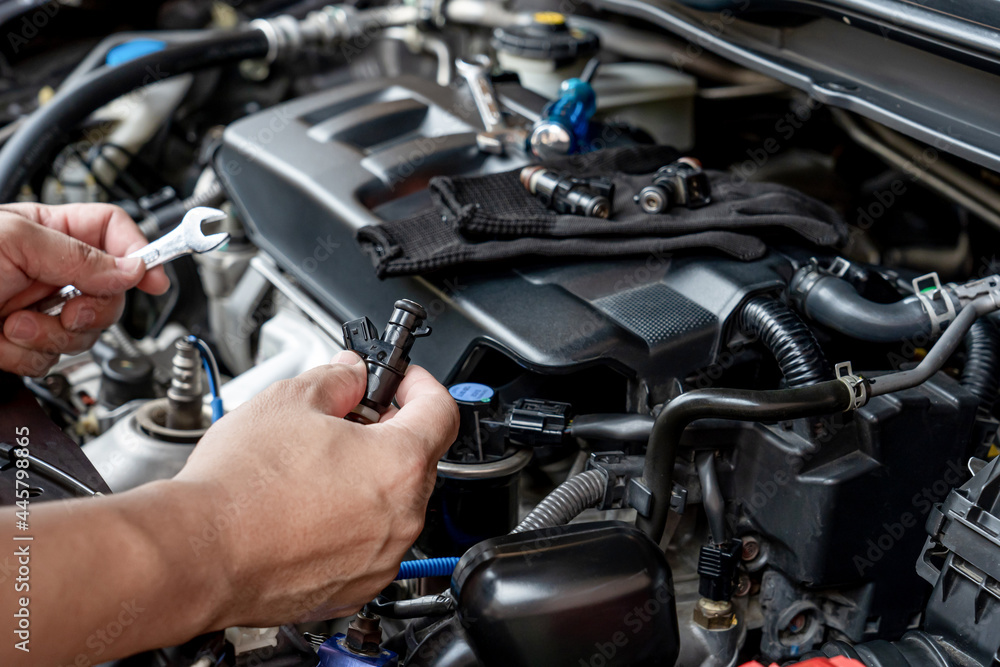 Technician Removing the gasoline injector part in engine room check dust and test pressure in process maintenance concept Technician Removing the gasoline injector part in engine room check dust and test pressure in process maintenance concept