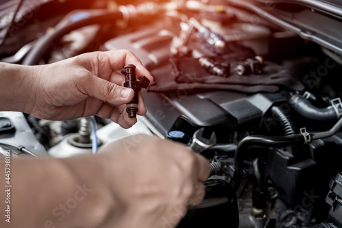 Cuadro en lienzo Technician use wrench removing the gasoline injector part on engine  maintenance