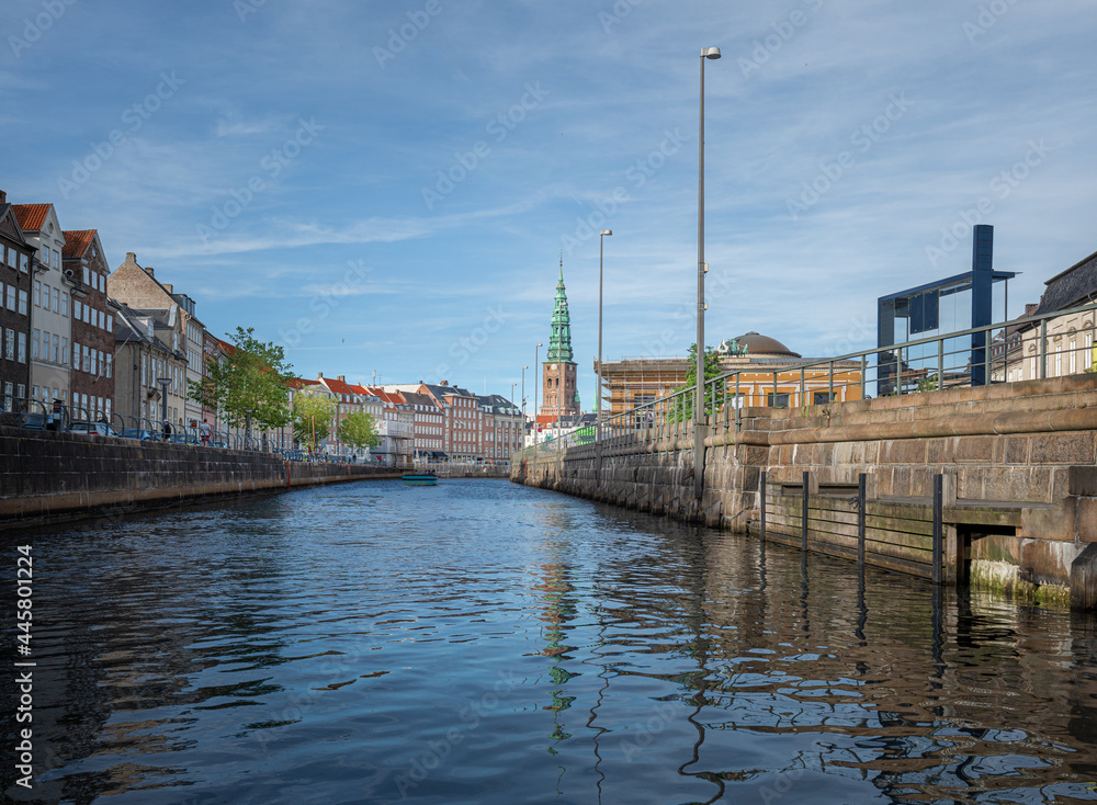 Fototapeta premium Frederikholms Canal with former Old St Nicholas Church Tower on Background - Copenhagen, Denmark