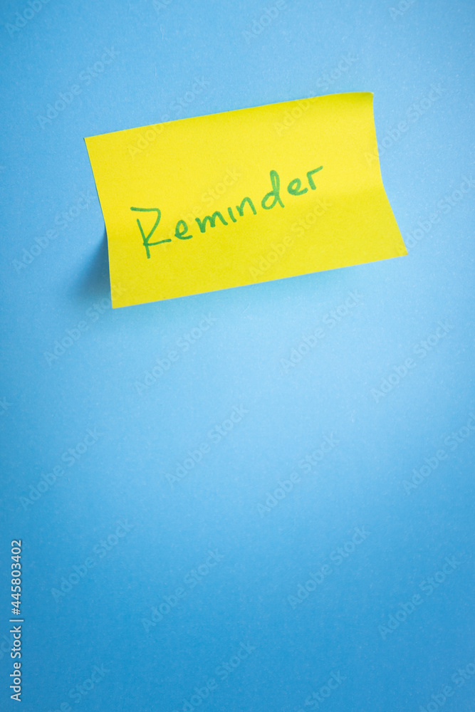 Reminder sticky note on blue light background. Minimalist concept. Copy space Reminder sticky note on blue light background. Minimalist concept. Copy space