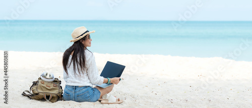 Photography Lifestyle freelance woman using laptop working and relax on the beach