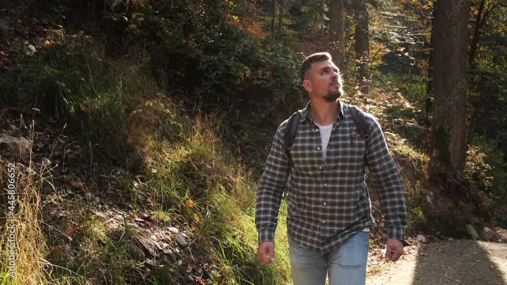 man is travelling alone in forest at autumn day man is travelling alone in forest at autumn day