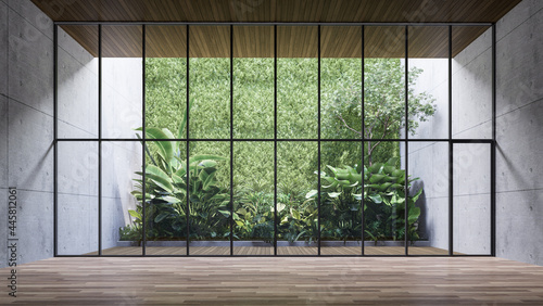Fotografie, Obraz Empty room with large window to see wooden courtyard and green tropical tree wal