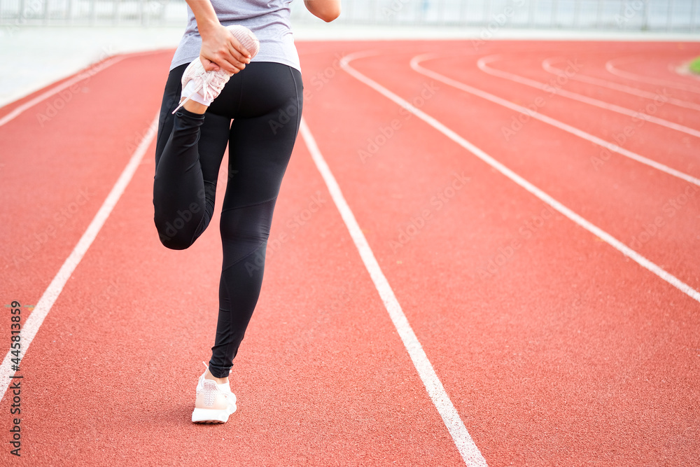Fitness women She stretched the leg muscles. Prepare to run in the running track Fitness women She stretched the leg muscles. Prepare to run in the running track