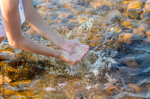In children's palms there is clear transparent river water. 