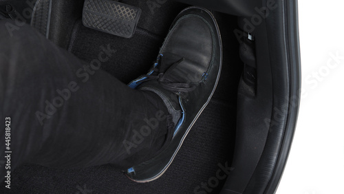Man foot and accelerator and brake pedal inside the car or vehicle and copy space which black color leather shoe stepped on it for speed up or control automobile pace power. Automobile Driving concept © gnepphoto
