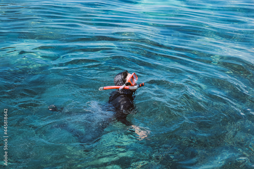 Woman swimming snorkeling in the clear water sea