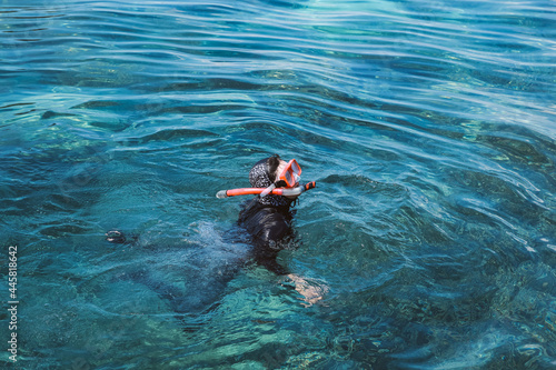 Woman swimming snorkeling in the clear water sea