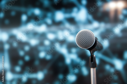 Microphone Public speaking background, Close-up the microphone on stand for speaker speech presentation stage performance with blur and bokeh light background.