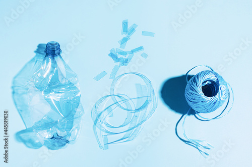 The concept recycling plastic. Empty plastic bottle recycled polyester fiber recycled products against blue background photo