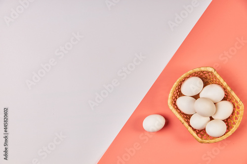 Eggs for Easter in a basket pink white background