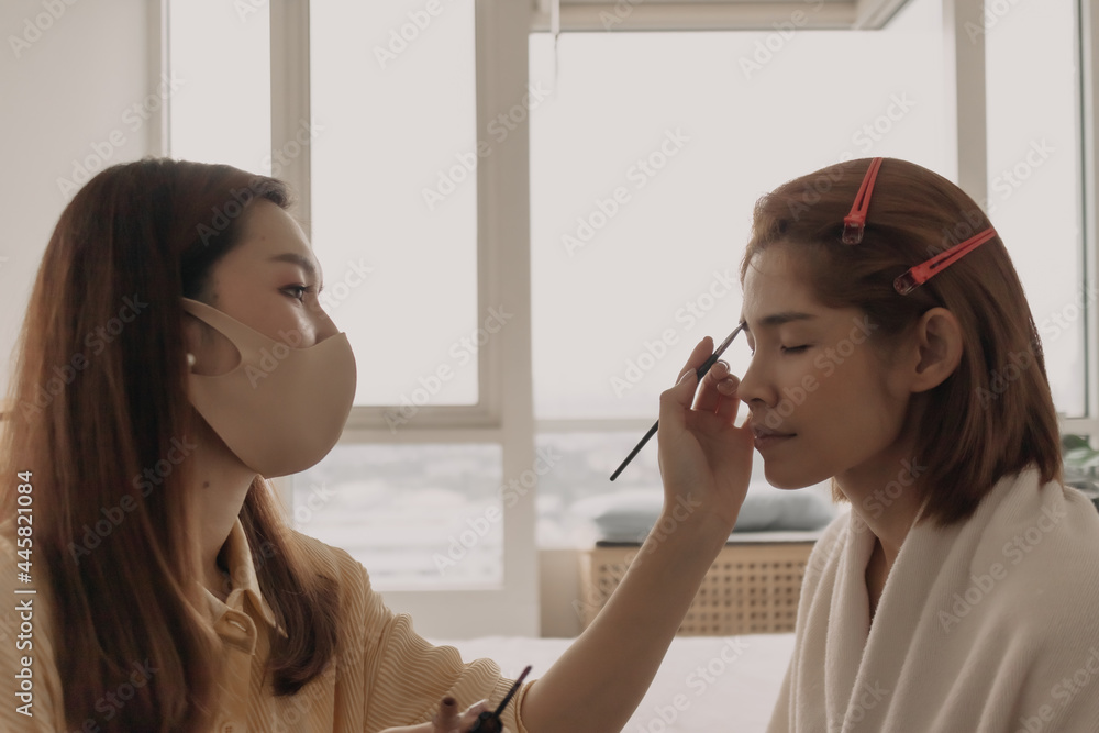 The makeup artist is applying makeup on client eyes. The makeup artist is applying makeup on client eyes.