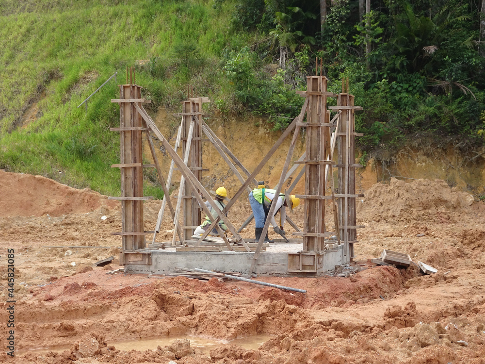 PENANG, MALAYSIA -MAY 3, 2020: Structural work is underway at the construction site. Work is carried out in stages according to the sequence of work. The workers practice standard safety methods. PENANG, MALAYSIA -MAY 3, 2020: Structural work is underway at the construction site. Work is carried out in stages according to the sequence of work. The workers practice standard safety methods.