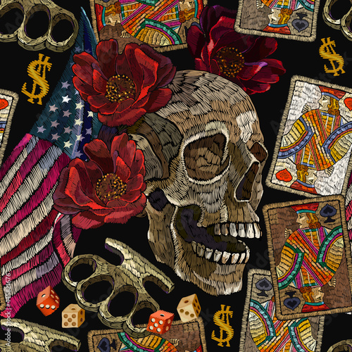 Embroidery skulls, roses flowers, brass knuckles, playing cards and rippled American flag, seamless pattern. Template for clothes, t-shirt design. Street culture style. Casino lifestyle background