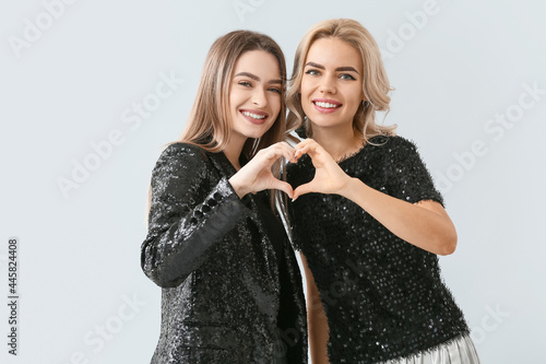 Beautiful young sisters mak...
