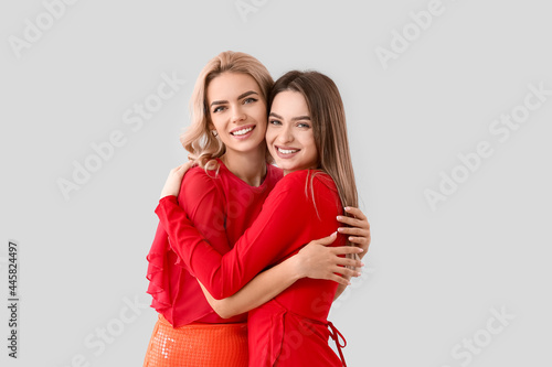 Konstfotografi Beautiful young sisters on light background