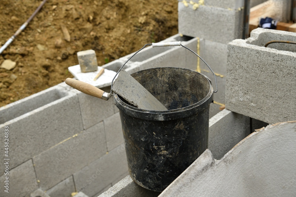 Hod bucket, mortar and mortar trowel on construction site homemade Hod bucket, mortar and mortar trowel on construction site homemade