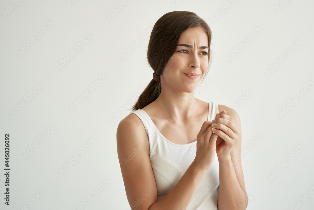 pretty woman in white t-shirt health problems injured arm pain pretty woman in white t-shirt health problems injured arm pain