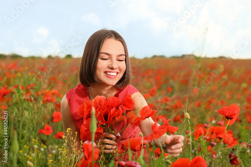 Beautiful young woman in poppy field © Pixel-Shot