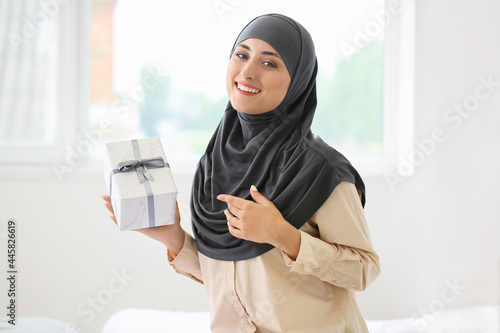 Young Muslim woman with gif...