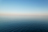 Seemless background of a calm sea with a cloudless sky at sunset with copyspace