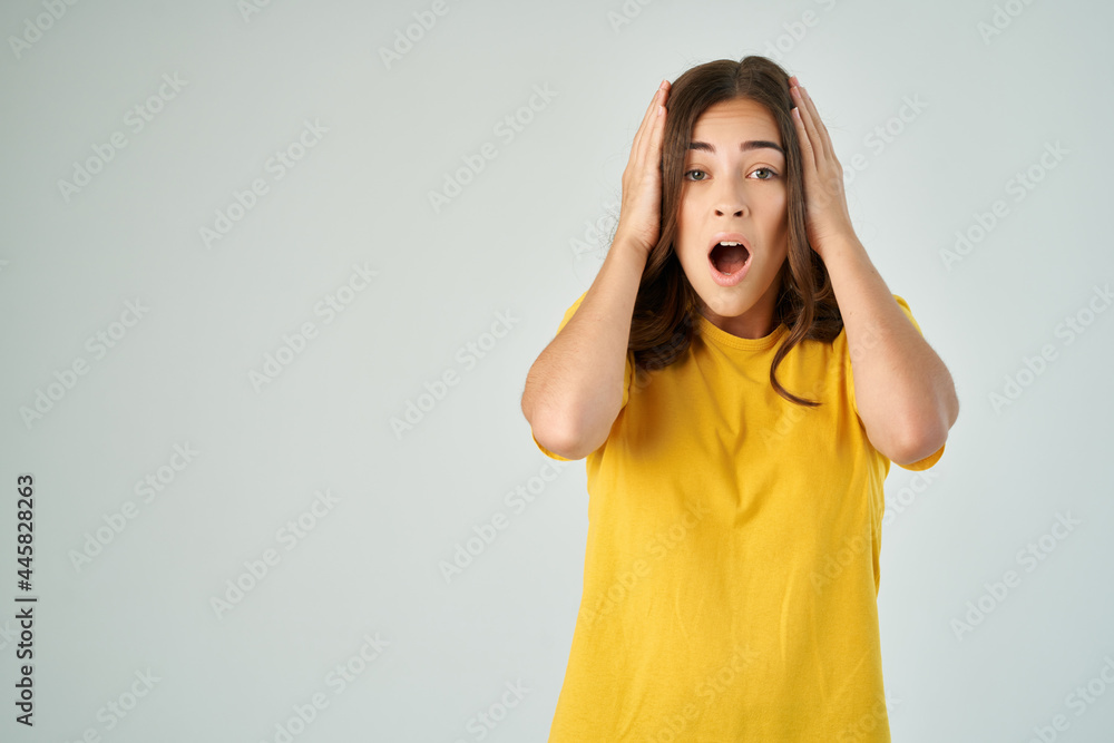 surprised woman in yellow t-shirt holding her head emotions cropped view surprised woman in yellow t-shirt holding her head emotions cropped view
