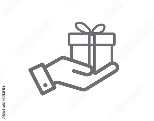 Gift box in hand isolated on white background. Hand hold gift. Design for website and mobile apps. Line icon. Vector illustration.