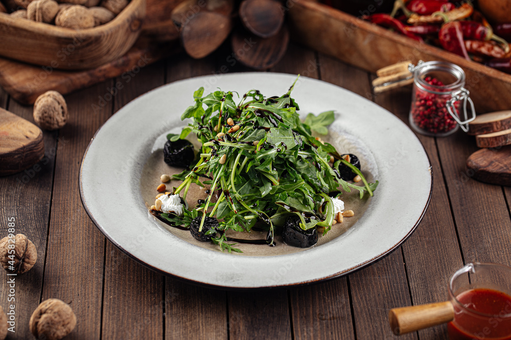 Beet root and arugula salad with goat cheese on a wooden background