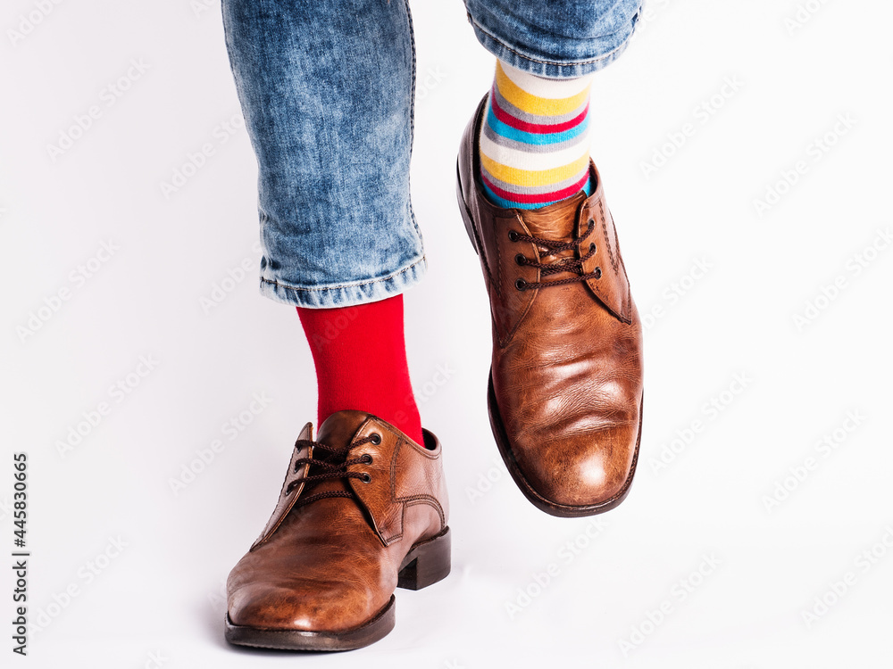 Men's legs, trendy shoes and bright socks. Close-up. Style, beauty and elegance concept Men's legs, trendy shoes and bright socks. Close-up. Style, beauty and elegance concept