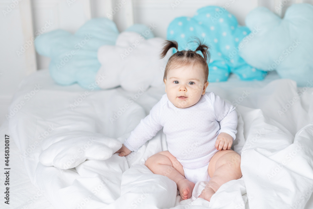 baby in bed on the bed at home, the concept of a happy loving family and children baby in bed on the bed at home, the concept of a happy loving family and children