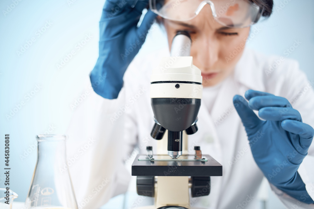 woman in laboratory looking through microscope close-up biotechnology science woman in laboratory looking through microscope close-up biotechnology science