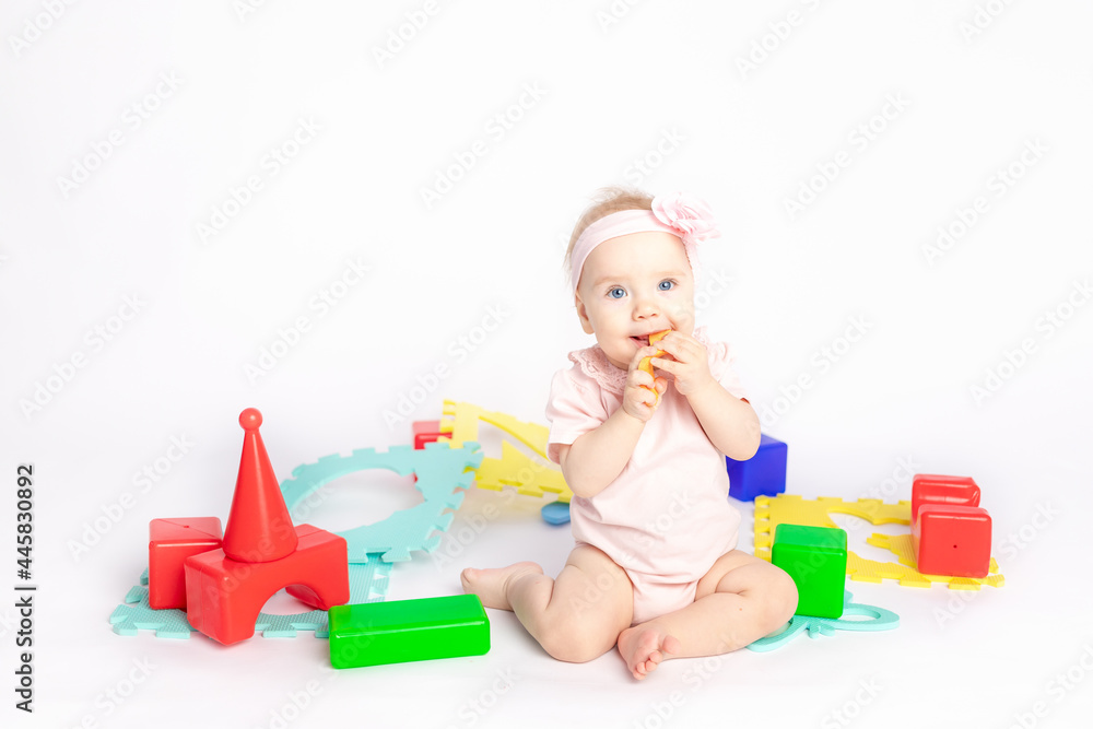 the kid plays with cubes on a white isolated background, space for text