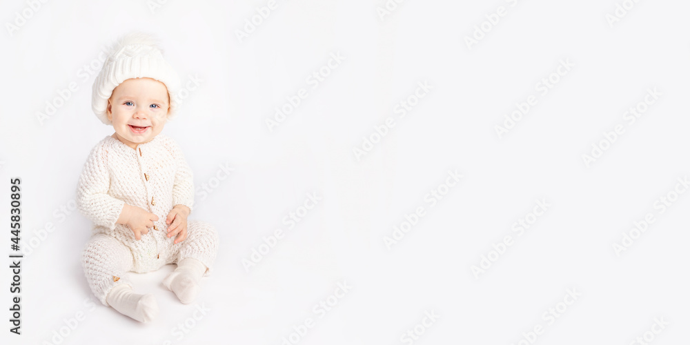 baby crawls in a warm suit and hat on a white isolated background, space for text baby crawls in a warm suit and hat on a white isolated background, space for text