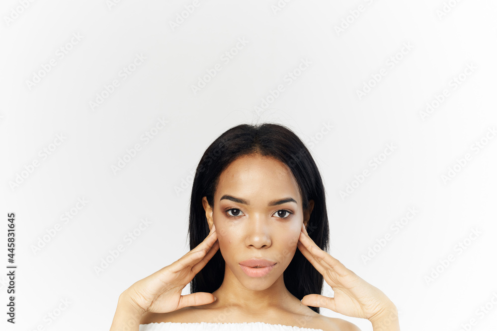woman of african appearance in white dress cosmetics on face cropped view model woman of african appearance in white dress cosmetics on face cropped view model