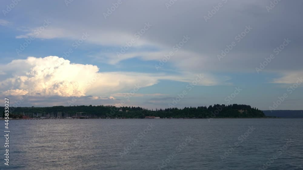 Adriatic Sea and green coast in Slovenia. Storm cloud forming in the distance. Beautiful summer evening. Handheld, real time, wide angle Adriatic Sea and green coast in Slovenia. Storm cloud forming in the distance. Beautiful summer evening. Handheld, real time, wide angle