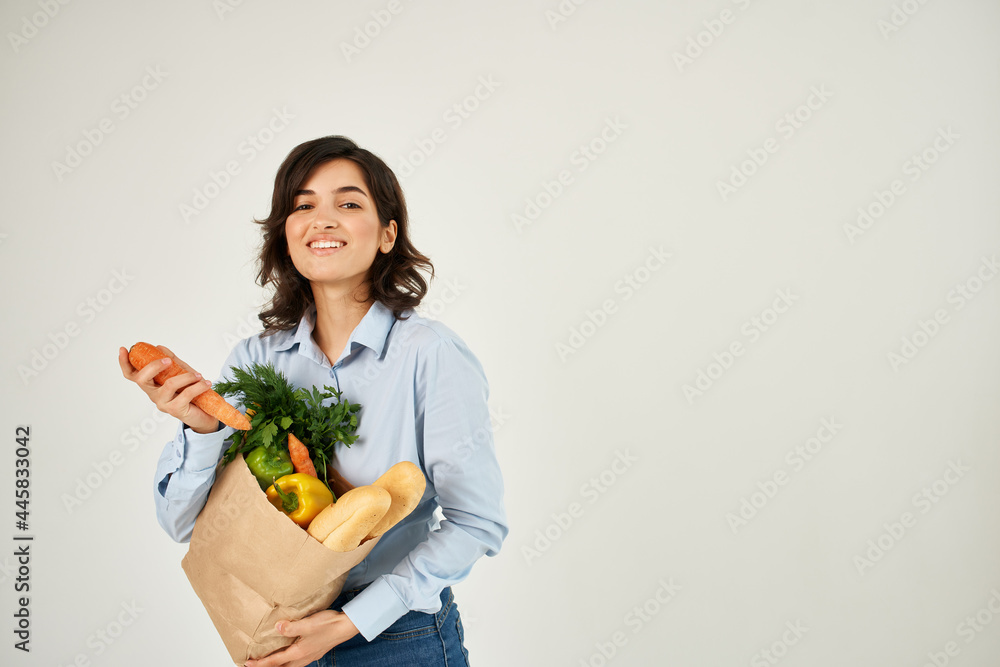 woman with a package of products carrot in hands vegetables supermarket healthy food woman with a package of products carrot in hands vegetables supermarket healthy food