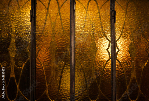 Photography Vintage glass doors with patterns on yellow non-transparent glass