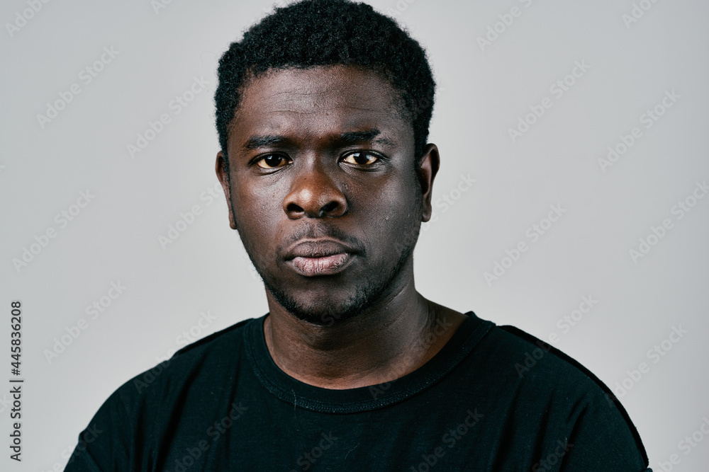 handsome man of african appearance in black t-shirt pensive look handsome man of african appearance in black t-shirt pensive look