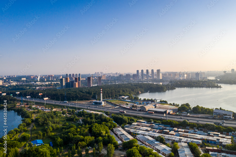 Fototapeta premium panoramic view of a green residential area near the lake filmed from a drone 