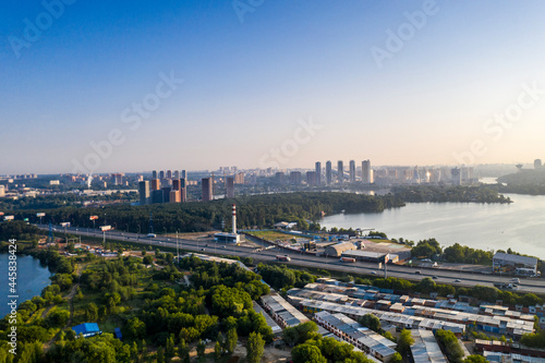 panoramic view of a green residential area near the lake filmed from a drone  © константин константи