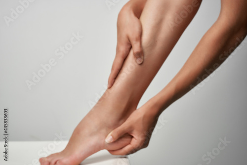 Fototapeta Naklejka Na Ścianę i Meble -  female leg massage injury treatment medicine health
