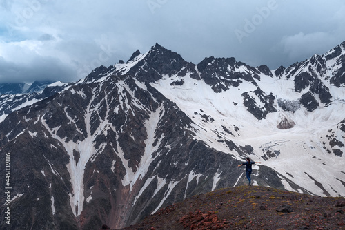 The Caucasian mountain range. Mount Elbrus volcano. The girl at the edge of the cliff. © mazurevanasta