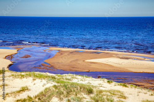 The small freshwater Peterupe river flows into the Baltic Sea near the White Dune in Saulkrasti, Latvia	
 photo