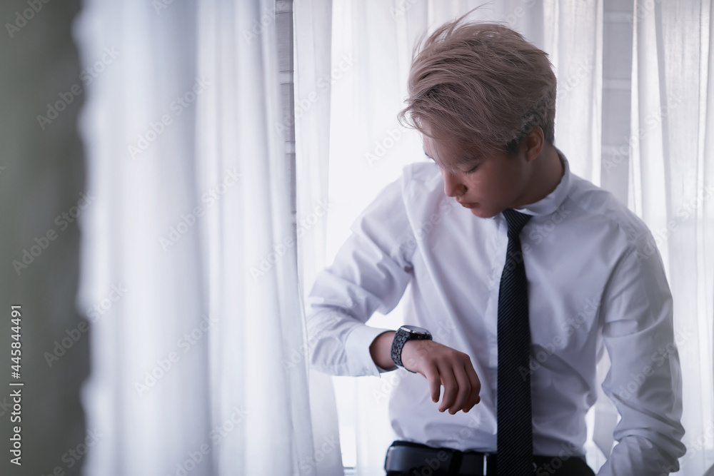 Young Asian businessman in white shirt and tie