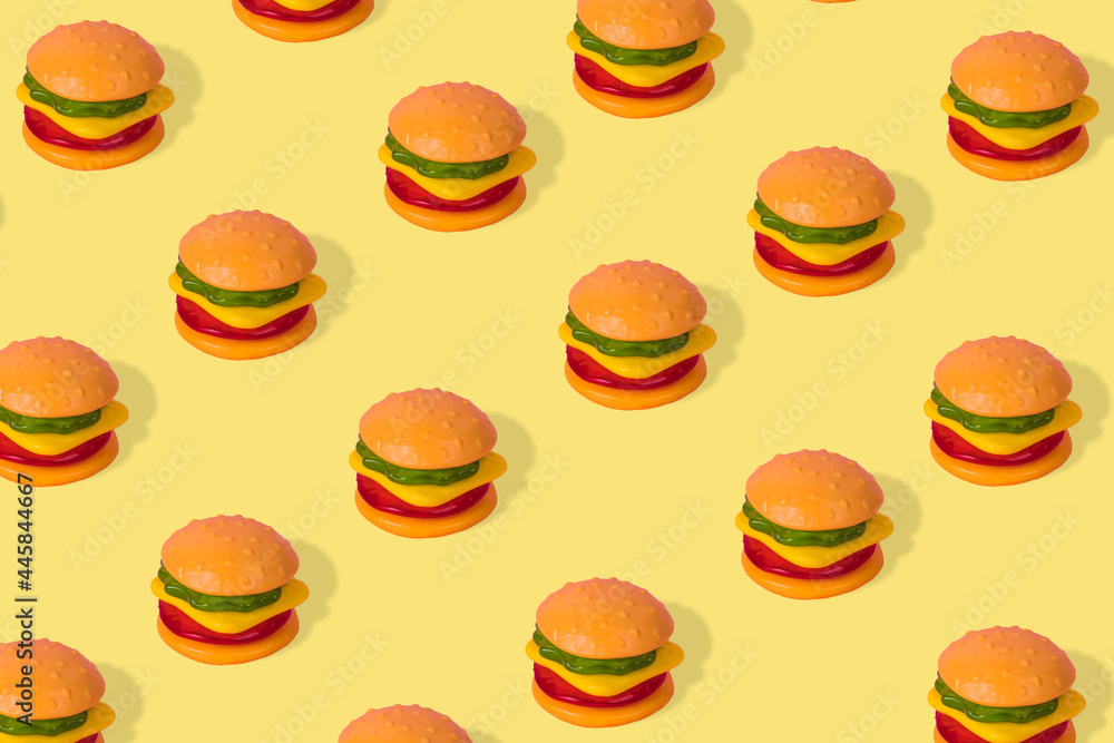Creative trendy idea fast food pattern-  Hamburger on a yellow background