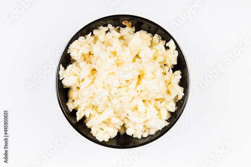 finely chopped garlic put in a bowl on a white background for cooking and cooking
