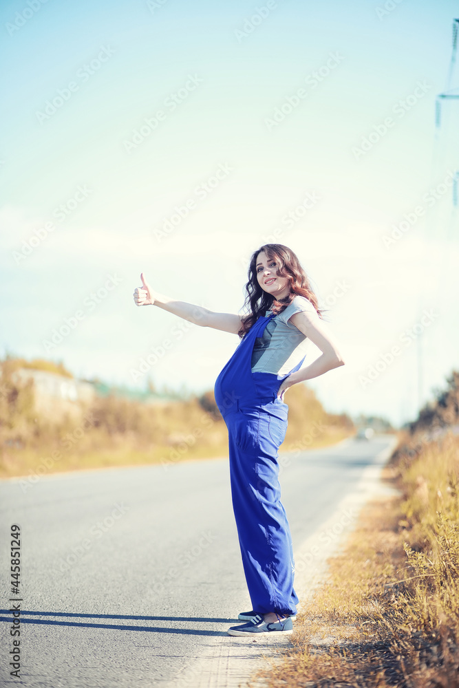 Pregnant woman hitchhiking the car Pregnant woman hitchhiking the car
