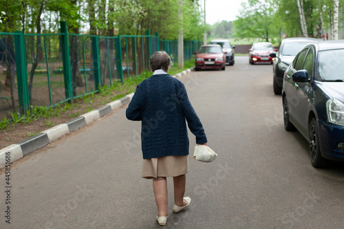 The pensioner goes to the shop. A woman in Russia walks through the city.