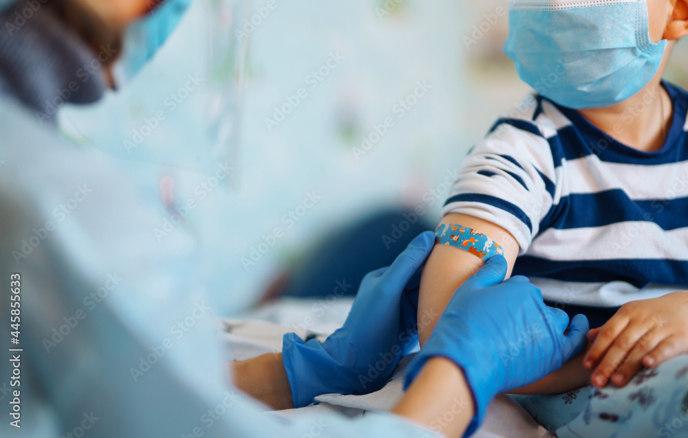 People vaccination concept for immunity health. Covid-19.  Children's doctor vaccinating little boy at home. Healthcare, coronavirus, prevention and immunize. - obrazy, fototapety, plakaty 